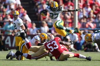 SAN FRANCISCO, CA - SEPTEMBER 08:  Running back Eddie Lacy #27 of the Green Bay Packers leaps over NaVorro Bowman #53 of the San Francisco 49ers in the fourth quarter at Candlestick Park on September 8, 2013 in San Francisco, California. The 49ers defeate