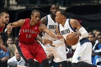 Dec 20, 2013; Dallas, TX, USA; Dallas Mavericks small forward Shawn Marion (0) drives around Toronto Raptors shooting guard DeMar DeRozan (10) during the first quarter at American Airlines Center. Mandatory Credit: Kevin Jairaj-USA TODAY Sports