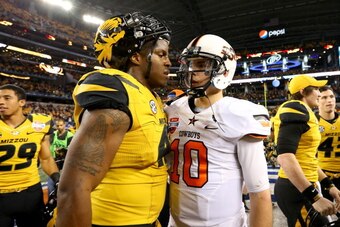 ARLINGTON, TX - JANUARY 03:  Kony Ealy #47 of the Missouri Tigers and Clint Chelf #10 of the Oklahoma State Cowboys walk into each other after the Tigers defeat the Cowboys 41-31 during the AT&T Cotton Bowl on January 3, 2014 in Arlington, Texas.  (Photo 