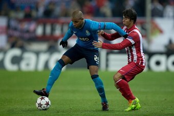 MADRID, SPAIN - DECEMBER 11:  Fernando Reges (L) of FC Porto competes for the ball with Oliver Torres (R) of Atletico de Madrid during the UEFA Champions League Group G match at Vicente Calderon Stadium on December 11, 2013 in Madrid, Spain.  (Photo by Go