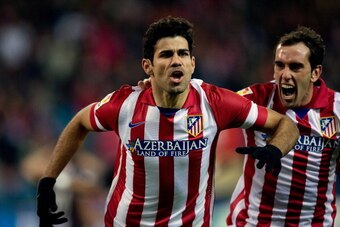MADRID, SPAIN - DECEMBER 21:  Diego Costa (L) of Atletico de Madrid celebrates scoring their second goal with team-mate Diego Godin (R) during the La Liga match between Club Atletico de Madrid and Levante UD at Vicente Calderon Stadium on December 21, 201