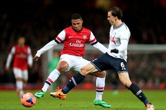 LONDON, ENGLAND - JANUARY 04:  Serge Gnabry of Arsenal and Vlad Chiriches of Spurs compete for the ball during the Budweiser FA Cup third round match between Arsenal and Tottenham Hotspur at Emirates Stadium on January 4, 2014 in London, England.  (Photo