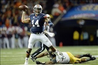 Dec 7, 2013; Atlanta, GA, USA; Auburn Tigers quarterback Nick Marshall (14) passes the ball in spite of the defense of Missouri Tigers defensive lineman Harold Brantley (90) during the second quarter of the 2013 SEC Championship game at Georgia Dome. Mand