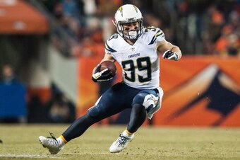 DENVER, CO - DECEMBER 12:  Running back Danny Woodhead #39 of the San Diego Chargers runs the ball against the Denver Broncos at Sports Authority Field Field at Mile High on December 12, 2013 in Denver, Colorado.  (Photo by Dustin Bradford/Getty Images)