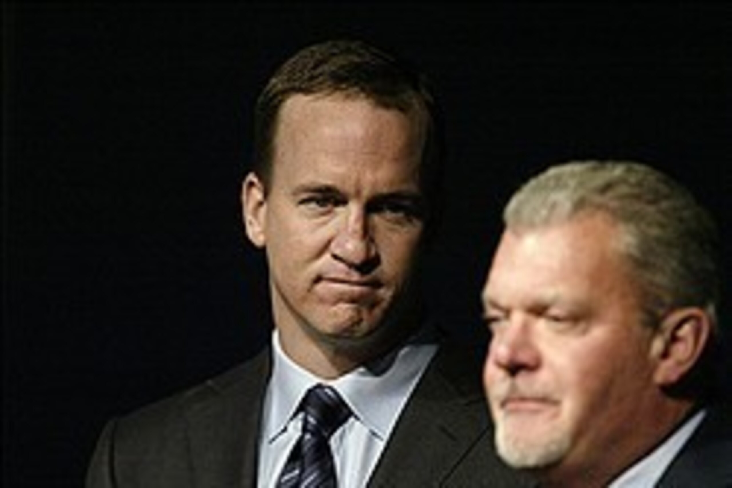 Mar 7, 2012; Indianapolis, IN, USA; Indianapolis Colts quarterback Peyton Manning (left) watches as owner Jim Irsay (right) announces Manning's release from the team during a press conference at the Indiana Farm Bureau Football Center. Mandatory Credit: B
