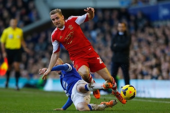 LIVERPOOL, ENGLAND - DECEMBER 29:  Luke Shaw of Southampton is tackled by Steven Naismith of Everton during the Barclays Premier League match between Everton and Southampton at Goodison Park on December 29, 2013 in Liverpool, England.  (Photo by Paul Thom