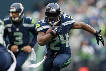 Dec 29, 2013; Seattle, WA, USA; Seattle Seahawks running back Marshawn Lynch (24) runs with the ball against the St. Louis Rams during the third quarter at CenturyLink Field. Mandatory Credit: Joe Nicholson-USA TODAY Sports