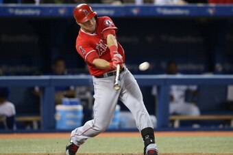 TORONTO, CANADA - SEPTEMBER 12: Mike Trout #27 of the Los Angeles Angels of Anaheim hits an RBI double in the fifth inning driving in the winning run during MLB game action against the Toronto Blue Jays on September 12, 2013 at Rogers Centre in Toronto, O