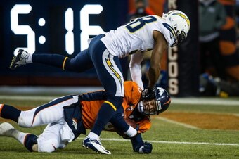 DENVER, CO - DECEMBER 12:  Quarterback Peyton Manning #18 of the Denver Broncos is sacked by strong safety Marcus Gilchrist #38 of the San Diego Chargers during a game at Sports Authority Field Field at Mile High on December 12, 2013 in Denver, Colorado. 
