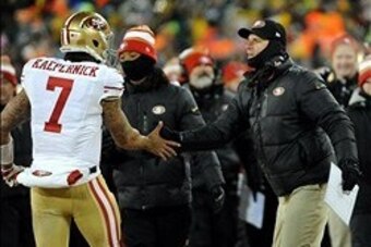 Jan 5, 2014; Green Bay, WI, USA;   San Francisco 49ers head coach Jim Harbaugh congratulates quarterback Colin Kaepernick (7) after Kaepernick threw a  28-yard touchdown pass to tight end Vernon Davis (not pictured) in the 4th quarter during the 2013 NFC 
