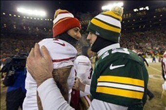 Jan 5, 2014; Green Bay, WI, USA; San Francisco 49ers quarterback Colin Kaepernick (7) greets Green Bay Packers quarterback Aaron Rodgers (12) following the 2013 NFC wild card playoff football game at Lambeau Field.  San Francisco won 23-20.  Mandatory Cre
