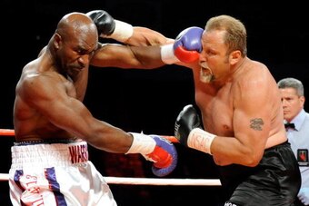 LAS VEGAS - APRIL 10:  Evander Holyfield (L) hits Francois Botha in the first round of their heavyweight bout at the Thomas & Mack Center April 10, 2010 in Las Vegas, Nevada. Holyfield won by TKO in the eighth round.  (Photo by Ethan Miller/Getty Images)