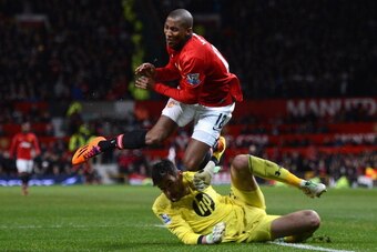 MANCHESTER, ENGLAND - JANUARY 01:  Hugo Lloris of Tottenham Hotspur collides with Ashley Young of Manchester United  during the Barclays Premier League match between Manchester United and Tottenham Hotspur at Old Trafford on January 1, 2014 in Manchester,