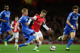 LONDON, ENGLAND - OCTOBER 29: Jack Wilshere of Arsenal is tackled by Kevin De Bruyne of Chelsea during the Capital One Cup Fourth Round match between Arsenal and Chelsea at the Emirates Stadium on October 29, 2013 in London, England.  (Photo by Jamie McDo