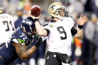 Dec 2, 2013; Seattle, WA, USA; New Orleans Saints quarterback Drew Brees (9) is pressured by Seattle Seahawks defensive end Michael Bennett (72) during the fourth quarter at CenturyLink Field. Mandatory Credit: Joe Nicholson-USA TODAY Sports