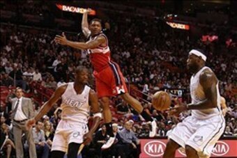 Dec 15, 2012; Miami, FL, USA;  Miami Heat shooting guard Dwyane Wade (3) passes the ball past Washington Wizards shooting guard Bradley Beal (3) to small forward LeBron James (6) for a basket in the second half at the American Airlines Arena. The Heat won