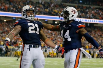 ATLANTA, GA - DECEMBER 07:  Tre Mason #21 of the Auburn Tigers celebrates his fourth quarter touchdown with teammate quarterback Nick Marshall #14 against the Missouri Tigers during the SEC Championship Game at Georgia Dome on December 7, 2013 in Atlanta,