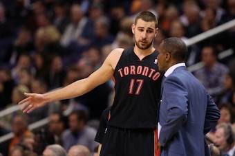 PHOENIX, AZ - DECEMBER 06:  Jonas Valanciunas #17 of the Toronto Raptors talks with head coach Dwane Casey during the NBA game against the Phoenix Suns at US Airways Center on December 6, 2013 in Phoenix, Arizona. The Suns defeated the Raptors 106-97.  NO