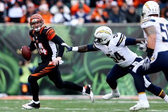 CINCINNATI, OH - JANUARY 05: Quarterback Andy Dalton #14 of the Cincinnati Bengals is pressured by outside linebacker Melvin Ingram #54 of the San Diego Chargers during a Wild Card Playoff game at Paul Brown Stadium on January 5, 2014 in Cincinnati, Ohio.