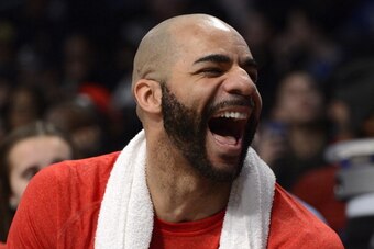 NEW YORK, NY - DECEMBER 25:  Carlos Boozer #5 of the Chicago Bulls laughs as he sits on the bench during the fourth quarter against the Brooklyn Nets at the Barclays Center on December 25, 2013 in the Brooklyn borough of New York City. NOTE TO USER: User 