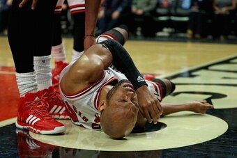 CHICAGO, IL - JANUARY 02:  Taj Gibson #22 of the Chicago Bulls hits the floor hard after a flagrant foul by Jared Sullinger of the Boston Celtics at the United Center on January 2, 2014 in Chicago, Illinois. The Bulls defeated the Celtics 94-82. NOTE TO U