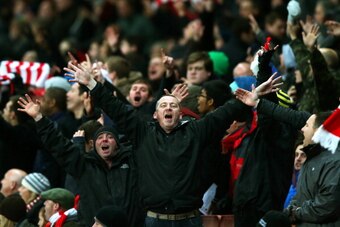 LONDON, ENGLAND - JANUARY 04:  Arsenal fans celebrate their team's 2-0 victory during the Budweiser FA Cup third round match between Arsenal and Tottenham Hotspur at Emirates Stadium on January 4, 2014 in London, England.  (Photo by Clive Rose/Getty Image
