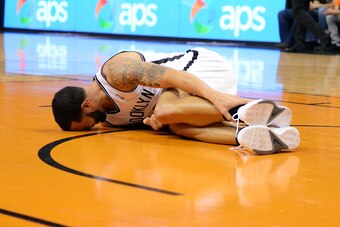 Nov 15, 2013; Phoenix, AZ, USA; Brooklyn Nets guard Deron Williams (8)  holds his ankle while laying on the court in the first half of the game against the Phoenix Suns at US Airways Center. Mandatory Credit: Jennifer Stewart-USA TODAY Sports