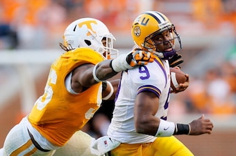 KNOXVILLE, TN - OCTOBER 15:  Jordan Jefferson #9 of the LSU Tigers rushes away from Curt Maggitt #56 of the Tennessee Volunteers at Neyland Stadium on October 15, 2011 in Knoxville, Tennessee.  (Photo by Kevin C. Cox/Getty Images)