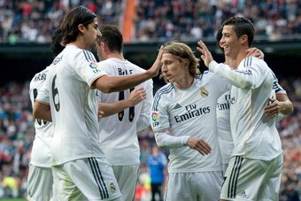 MADRID, SPAIN - NOVEMBER 09:  Cristiano Ronaldo (R) of Real Madrid CF celebrates scoring their fifth goal with teammates Luka Modric (2ndR) and Sami Khedira (L) during the La Liga match between Real Madrid CF and Real Sociedad de Futbol  at Estadio Santia