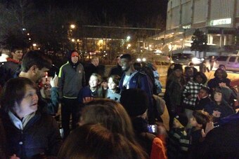 Senior defensive end Dee Ford takes photos with fans as he leaves the Auburn athletics complex.