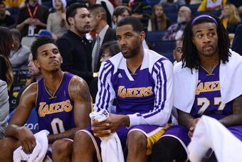 December 21, 2013; Oakland, CA, USA; Los Angeles Lakers small forward Nick Young (0), power forward Shawne Williams (3, center), and center Jordan Hill (27, right) react on the bench during the fourth quarter against the Golden State Warriors at Oracle Ar