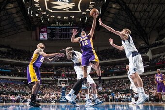 DALLAS, TX - JANUARY 7: Kendall Marshall #12 of the Los Angeles Lakers goes in for the lay up against Dirk Nowitzki #41 of the Dallas Mavericks on January 7, 2014 at the American Airlines Center in Dallas, Texas. NOTE TO USER: User expressly acknowledges 