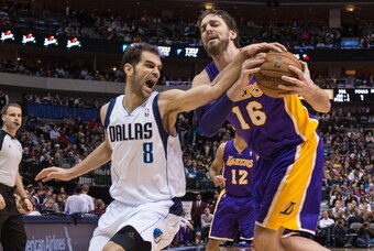 Jan 7, 2014; Dallas, TX, USA; Dallas Mavericks point guard Jose Calderon (8) battles for the ball with Los Angeles Lakers center Pau Gasol (16) during the second half at the American Airlines Center. The Mavericks won 110-97. Mandatory Credit: Jerome Miro