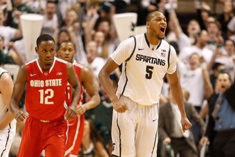 EAST LANSING, MI - JANUARY 07:  Adreian Payne #5 of the Michigan State Spartans reacts to a three point shot he hit in overtime next to Sam Thompson #12 of the Ohio State Buckeyes at the Jack T. Breslin Student Events Center on January 7, 2014 in East Lan