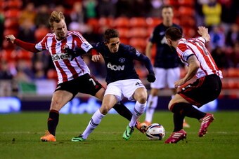 SUNDERLAND, ENGLAND - JANUARY 07:  Adnan Januzaj of Manchester United takes on Sebastian Larsson (L) and Phil Bardsley of Sunderland during the Capital One Cup Semi-Final, first leg match between Sunderland and Manchester United at Stadium of Light on Jan