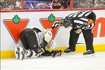 Dec 23, 2013; Ottawa, Ontario, CAN; Pittsburgh Penguins right wing Pascal Dupuis (9) is injured after colliding with center Sidney Crosby (87) in the first period against the Ottawa Senators at the Canadian Tire Centre. Mandatory Credit: Marc DesRosiers-U