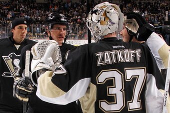 PITTSBURGH, PA - NOVEMBER 22: Jeff Zatkoff #37 of the Pittsburgh Penguins is congratulated by Sidney Crosby #87 after the game against the New York Islanders on November 22, 2013 at Consol Energy Center in Pittsburgh, Pennsylvania. (Photo by Gregory Shamu
