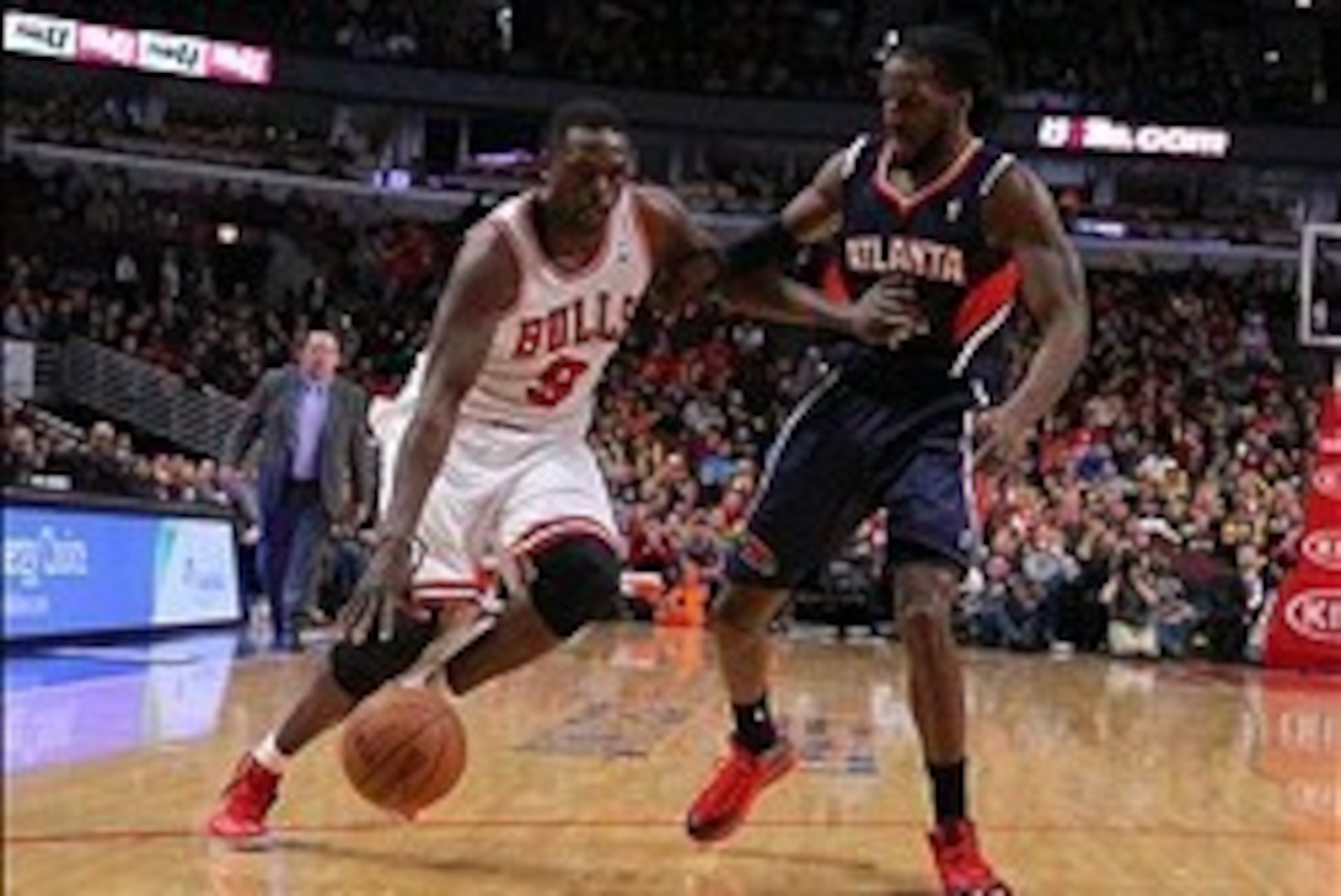 Jan 4, 2014; Chicago, IL, USA; Chicago Bulls small forward Luol Deng (9) drives against Atlanta Hawks small forward DeMarre Carroll (5) during the second half at the United Center. Chicago won 91-84. Mandatory Credit: Dennis Wierzbicki-USA TODAY Sports