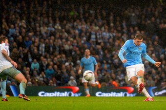 MANCHESTER, ENGLAND - JANUARY 08:  Edin Dzeko of Manchester City scores their sixth goal during the Capital One Cup Semi-Final first leg match between Manchester City and West Ham United at Etihad Stadium on January 8, 2014 in Manchester, England.  (Photo