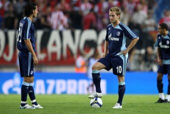 MADRID, SPAIN - AUGUST 27:  Kevin Kuranyi (L) and Ivan Rakitic of FC Schalke stand dejected at the halfway line after Atletico Madrid scored their second goal during the UEFA Champions League third Qualifying Round, second leg match between Atletico Madri