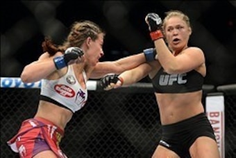 Dec 28, 2013; Las Vegas, NV, USA;    Ronda Rousey (red gloves) and Miesha Tate (blue gloves) during their UFC Women's Bantamweight Championship Bout at the MGM Grand Garden Arena. Ronda Rousey won Mandatory Credit: Jayne Kamin-Oncea-USA TODAY Sports