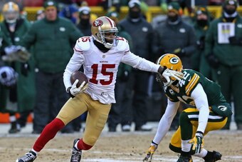 GREEN BAY, WI - JANUARY 05:  Michael Crabtree #15 of the San Fransico 49ers moves around Morgan Burnett #42 of the Green Bay Packers during an NFC Wild Card Playoff game at Lambeau Field on January 5, 2014 in Green Bay, Wisconsin. The 49ers defeated the P