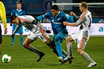 ST. PETERSBURG, RUSSIA - DECEMBER 06: Hulk of FC Zenit St. Petersburg (C) vies for the ball with Milan Vjestica of FC Ural Sverdlovsk Oblast (L) and Andrei Bochkov of FC Ural Sverdlovsk Oblast during the Russian Football League Championship match between 