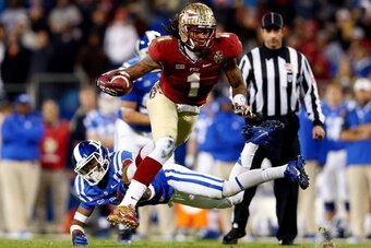 CHARLOTTE, NC - DECEMBER 07:  Wide receiver Kelvin Benjamin #1 of the Florida State Seminoles runs with the ball as cornerback Deondre Singleton #33 of the Duke Blue Devils defends during the ACC Championship game at Bank of America Stadium on December 7,