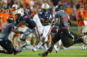 AUBURN, AL - SEPTEMBER 7:  Runningback Cameron Artis-Payne #44 of the Auburn Tigers runs through traffic during their game against the Arkansas State Red Wolves  on September 7, 2013 at Jordan-Hare Stadium in Auburn, Alabama. Auburn defeated Arkansas Stat