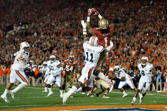Jan 6, 2014; Pasadena, CA, USA; Florida State Seminoles wide receiver Kelvin Benjamin (1) catches a touchdown pass over Auburn Tigers cornerback Chris Davis (11) during the second half of the 2014 BCS National Championship game at the Rose Bowl.  Mandator