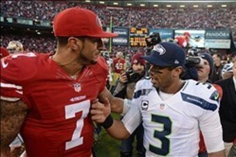 December 8, 2013; San Francisco, CA, USA; San Francisco 49ers quarterback Colin Kaepernick (7) shakes hands with Seattle Seahawks quarterback Russell Wilson (3) after the game at Candlestick Park. The 49ers defeated the Seahawks 19-17. Mandatory Credit: K