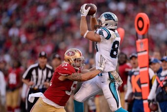 SAN FRANCISCO, CA - NOVEMBER 10:  Greg Olsen #88 of the Carolina Panthers makes the catch but gets pushed out of bounds by Dan Skuta #51 of the San Francisco 49ers for an incomplete pass during the fourth quarter at Candlestick Park on November 10, 2013 i