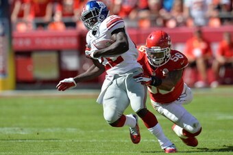 KANSAS CITY, MO - SEPTEMBER 29:  Running back David Wilson #22 of the New York Giants rushes past linebacker Derrick Johnson #56 of the Kansas City Chiefs during the second half on September 29, 2013 at Arrowhead Stadium in Kansas City, Missouri.  Kansas 