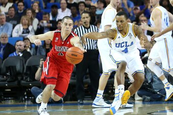 LOS ANGELES, CA - JANUARY 09: T.J. McConnell #4 of the Arizona Wildcats steals the ball from Norman Powell #4 of the UCLA Bruins before taking the ball the length of the court and scoring on a layup at Pauley Pavilion on January 9, 2014 in Los Angeles, Ca
